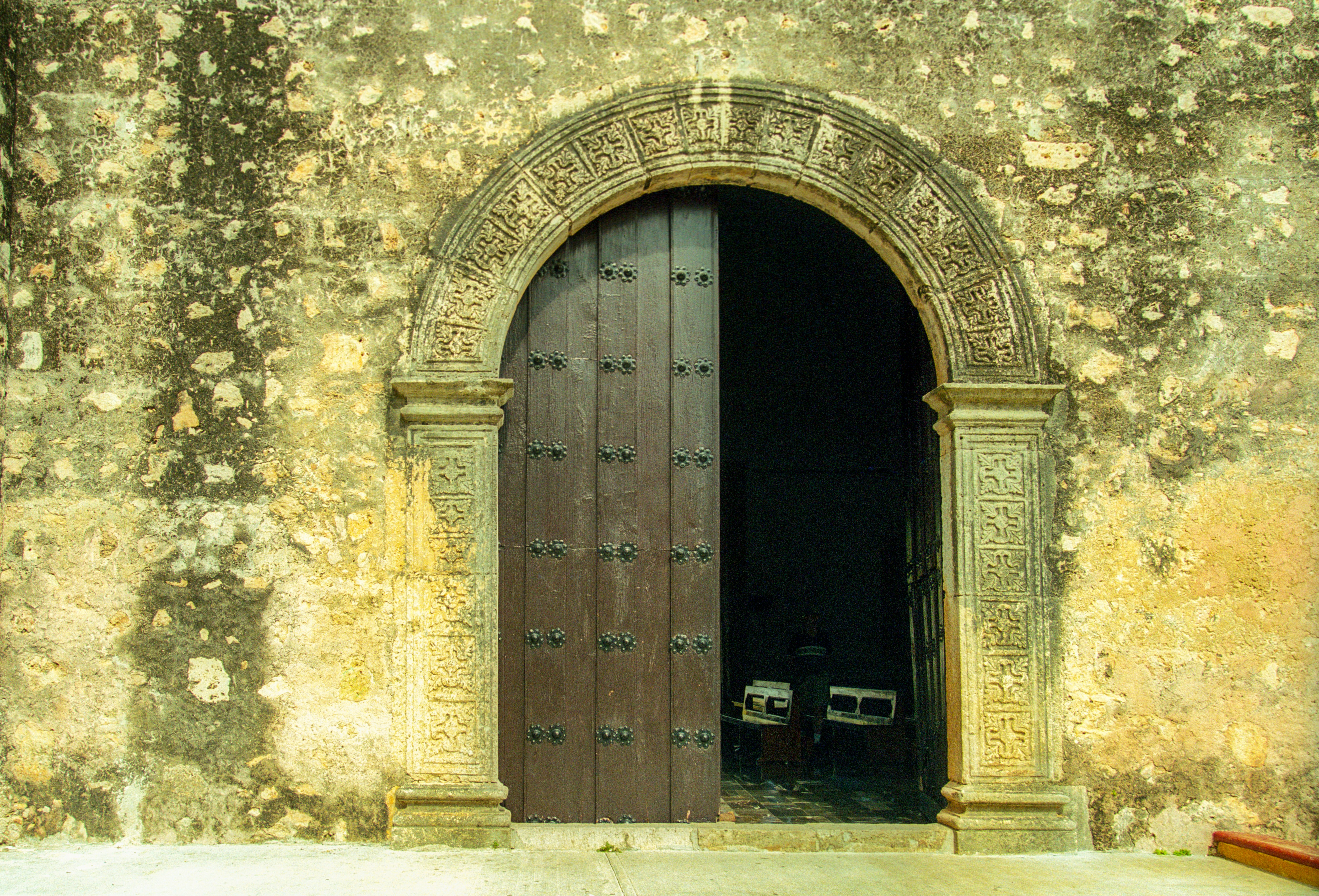 brown wooden door on gray concrete wall